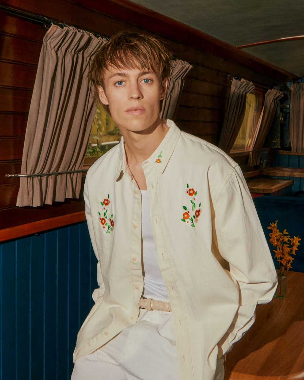 Men wearing a INGMARSON embroidered shirt on a narrow boat.